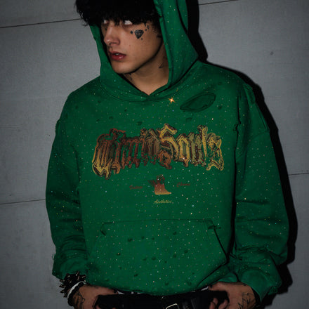 Person wearing a green hoodie with text, standing against a plain background
