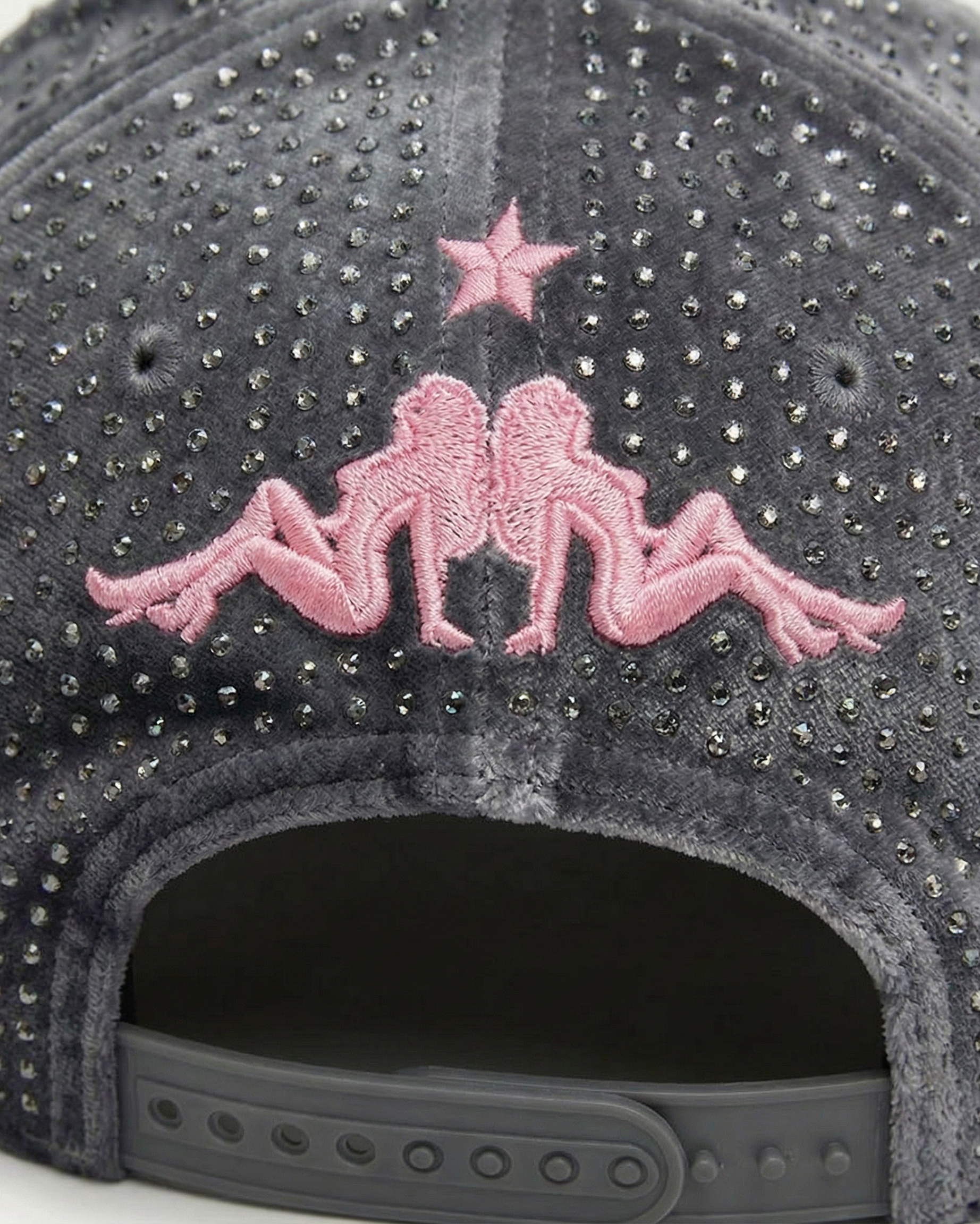 Gray cap with pink embellishments and a star on a white background