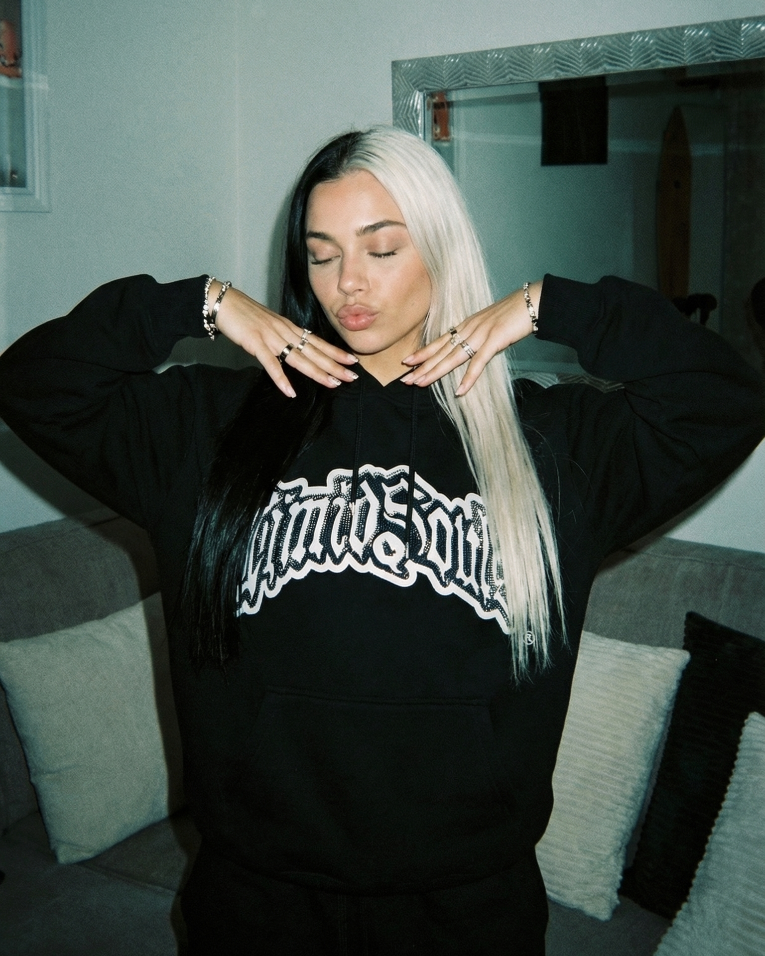 This image features a stylish "Black" LOGO® Hoodie, perfect for casual wear and made from all-cotton for comfort and durability. The hoodie sports a prominent blue rhinestone on the front, adding a touch of uniqueness and style.