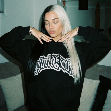 This image features a stylish "Black" LOGO® Hoodie, perfect for casual wear and made from all-cotton for comfort and durability. The hoodie sports a prominent blue rhinestone on the front, adding a touch of uniqueness and style.