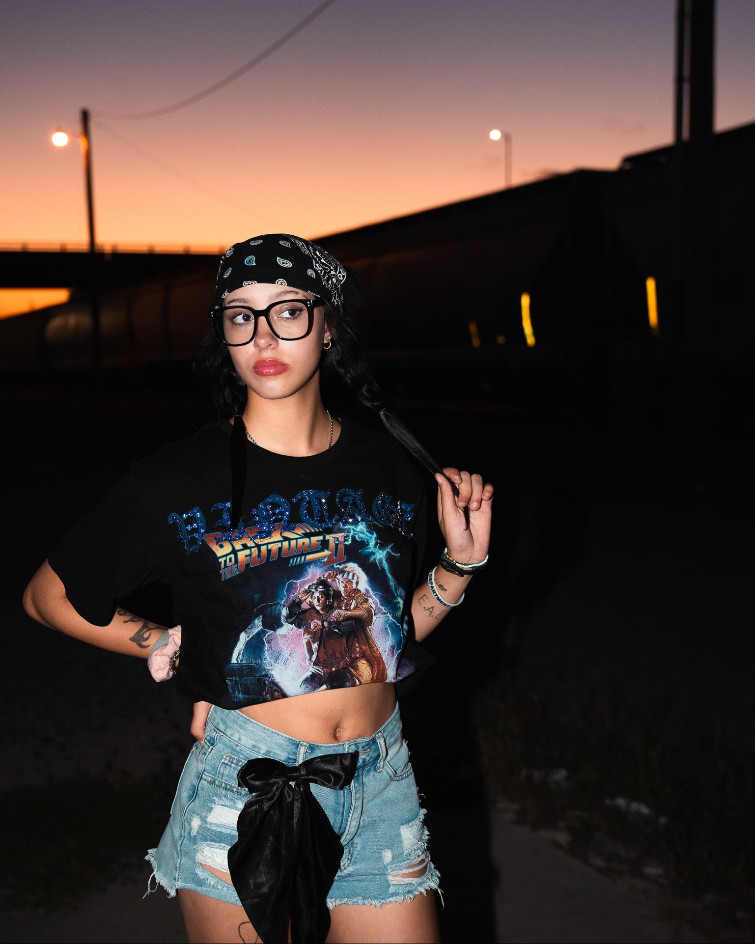 Person wearing a 'Back to the Future' shirt at sunset